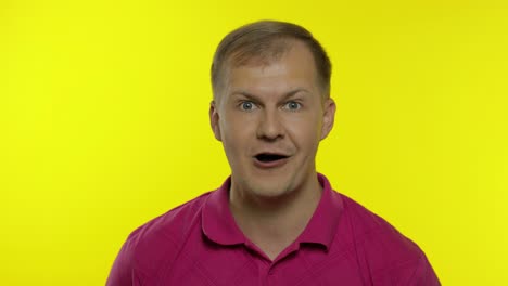 Portrait-of-caucasian-man-posing-in-pink-t-shirt.-Amazed-handsome-guy-shocked,-surprised,-say-wow