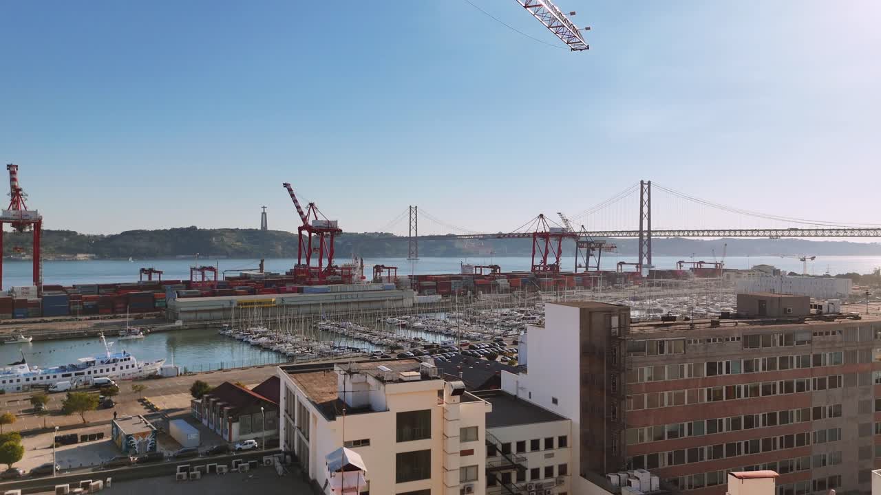 Aerial view of a port with a bridge and cityscape