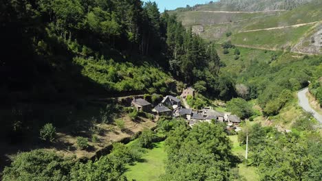 aerial drone shot of a little town on the valley of the green mountains of asturias, spain