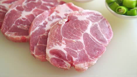 fresh pork neck raw or collar pork on board with ingredients for marinated