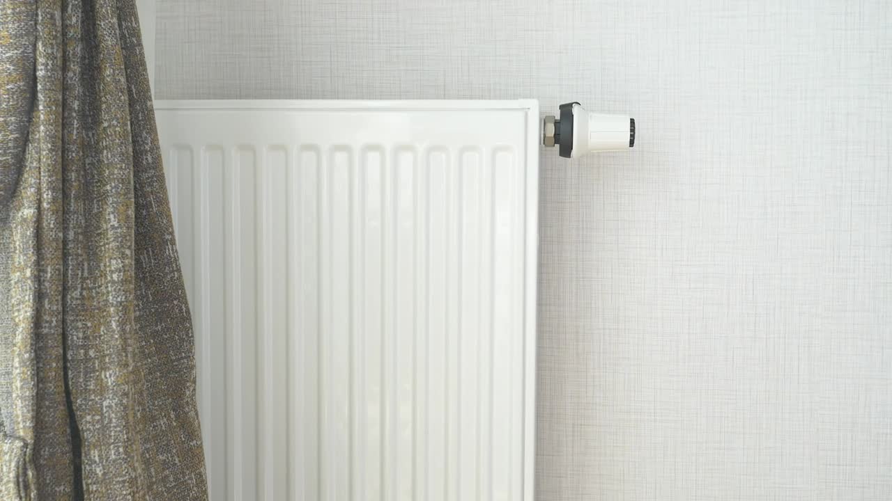 White Radiator with Thermostat in a Room