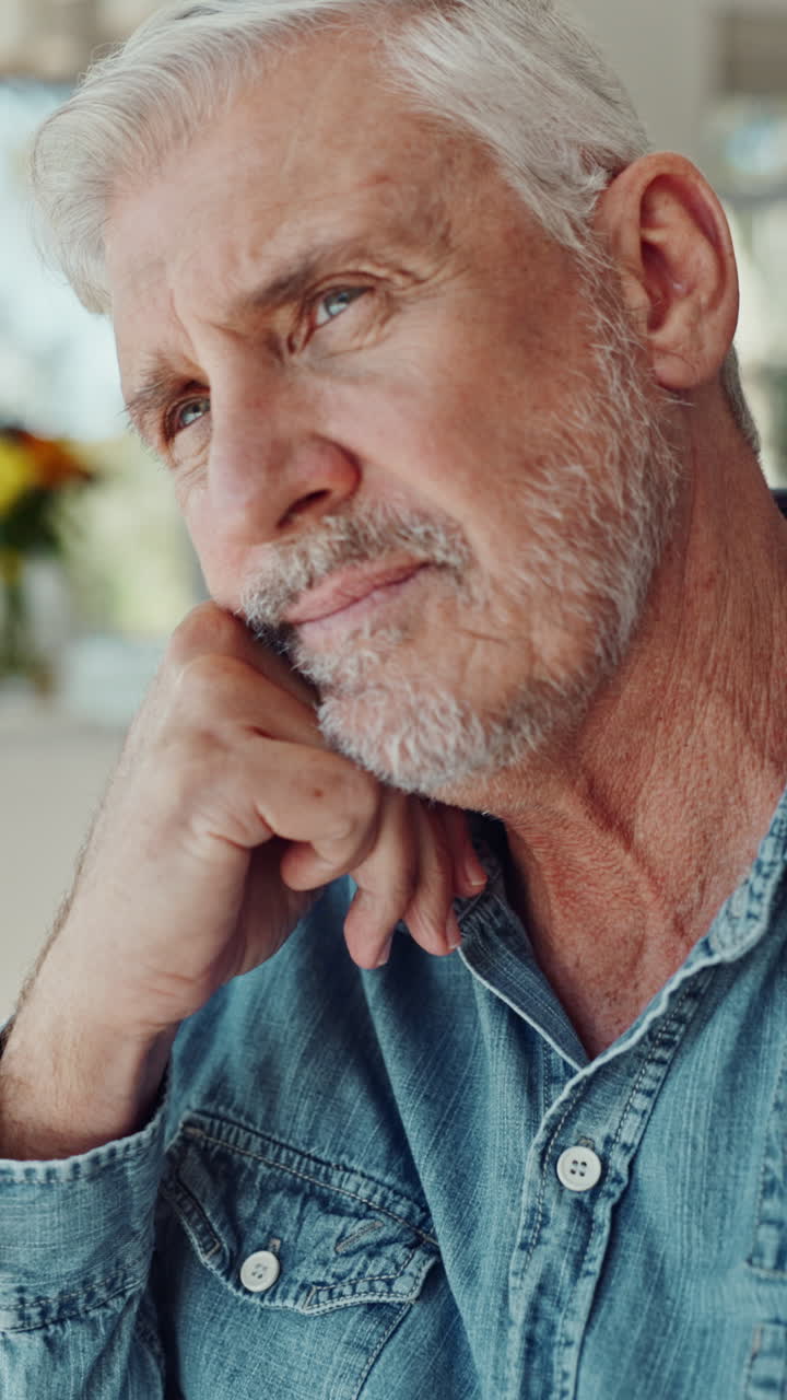 Close-up of Pensive Senior Man Resting Chin on Hand