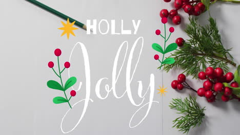 animación de un estandarte de texto holly jolly sobre bayas rojas y ramas de abeto en una superficie gris.