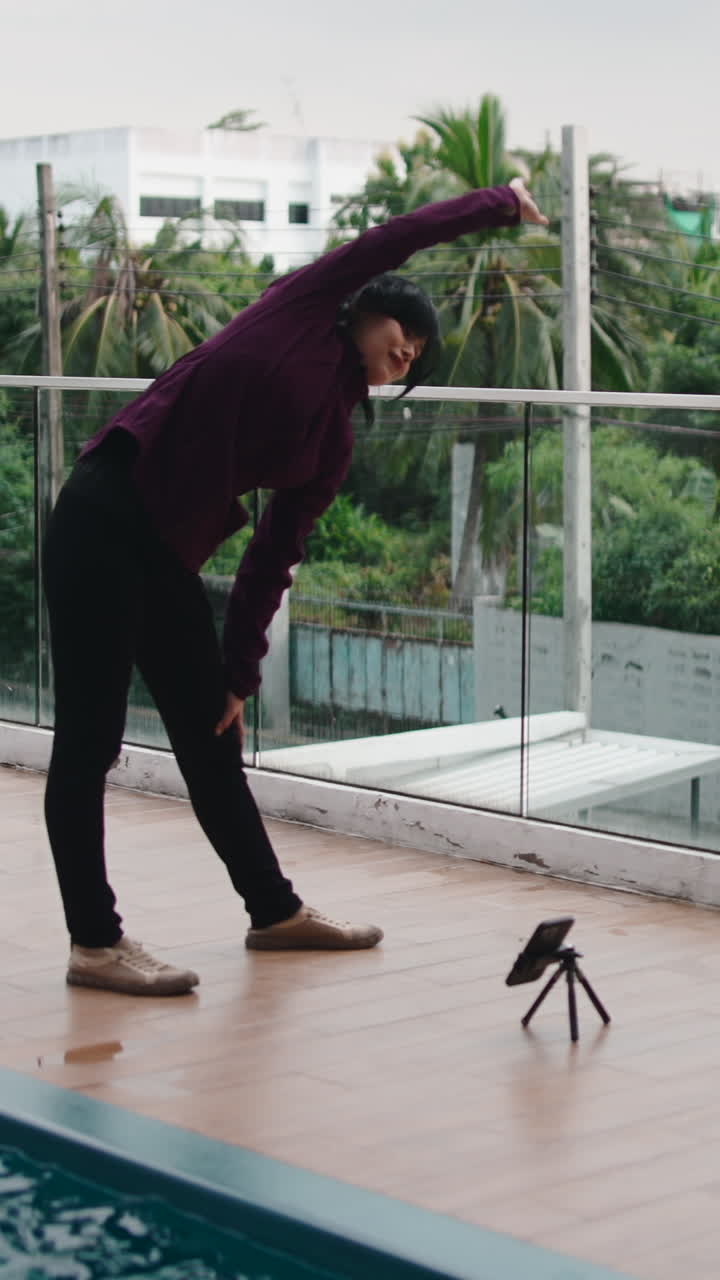 Woman stretching outdoors on balcony
