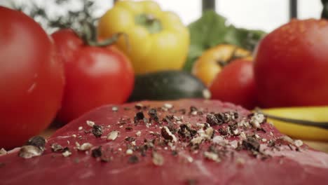 Zoom-out-macro-video-of-black-pepper-on-raw-steak