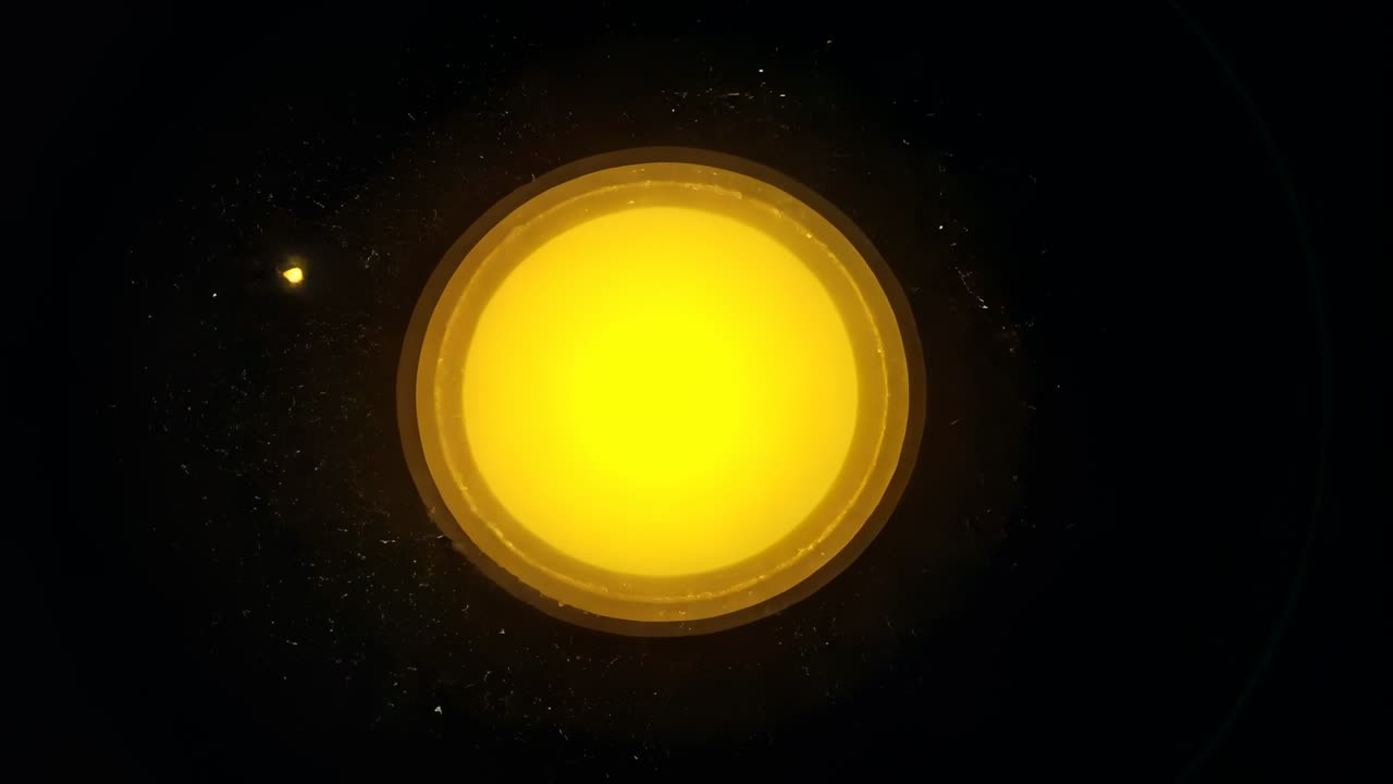 Initiating sequence glowing yellow orb pulsing rings in dark void, releasing golden particles