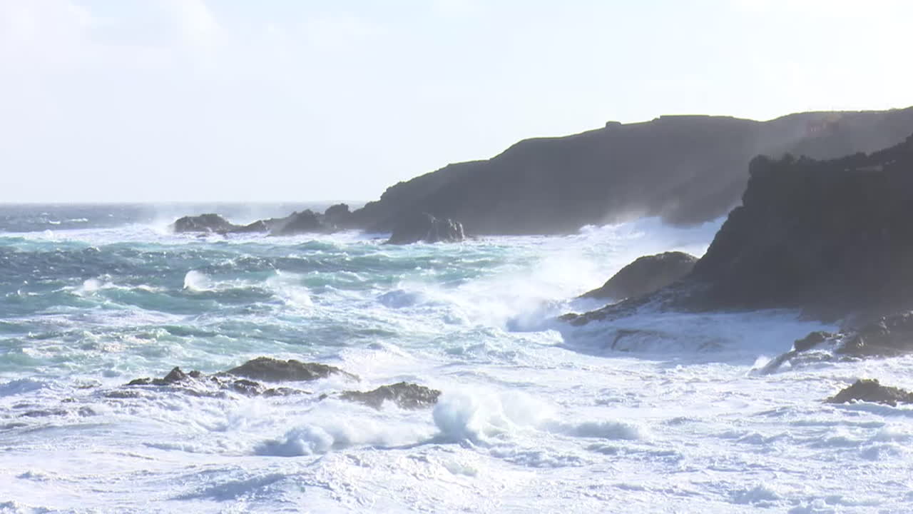 Powerful Waves Crashing on Rocky Coastline