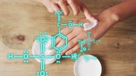 animation of chemical structures over biracial woman putting cream on her hand