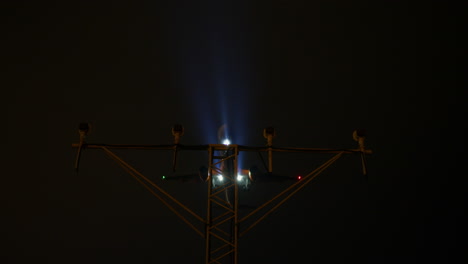 airplane landing at night with runway lights
