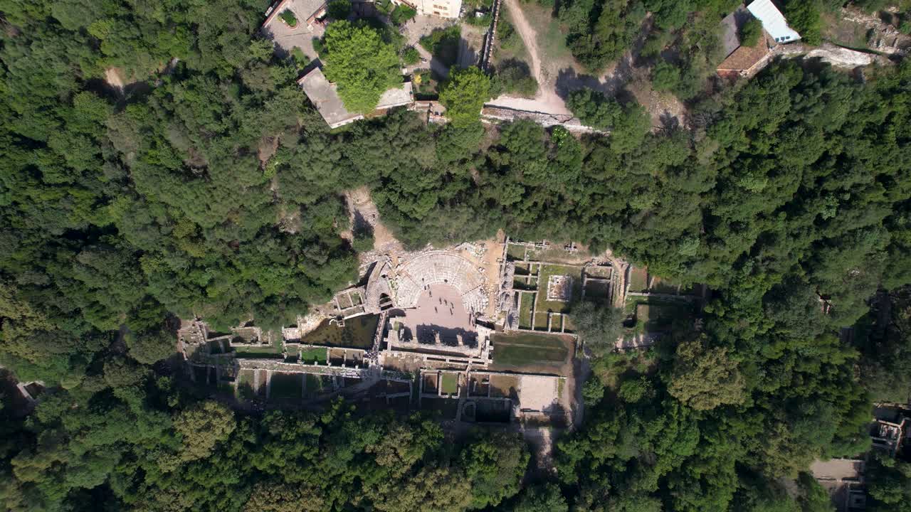 Butrint UNESCO Site &ndash; Amphitheater, Tower of Fortress, and Ancient Stone Walls on a Green Peninsula, Aerial view