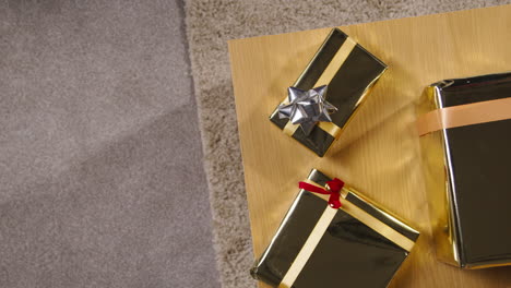 overhead shot of gifts or presents wrapped on table at home 1