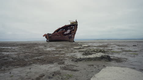 motion lapse of a shipwreck with crabs exposed by the low tide near motueka, tasman new zealand