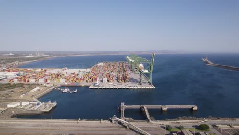 Sines-port,-Cargo-terminal-packed-with-colorful-containers,-Aerial-orbiting-shot