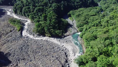 aerial drone flyover parque braulio carrillo national park and rio sucio bridge, costa rica 4k