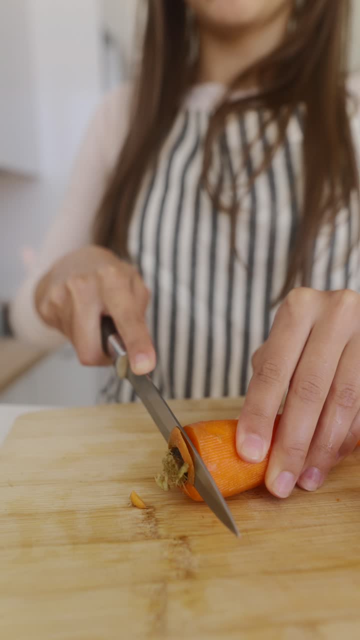 Young girl cutting carrots