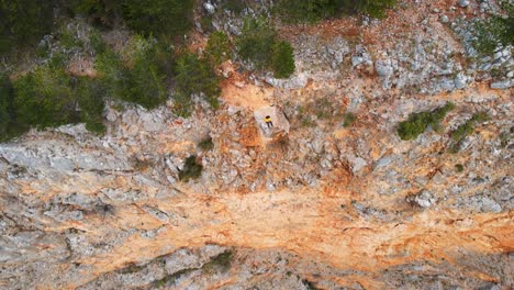 A-tourist-flying-a-drone-on-the-edge-of-Red-Lake,-the-biggest-doline-in-Europe