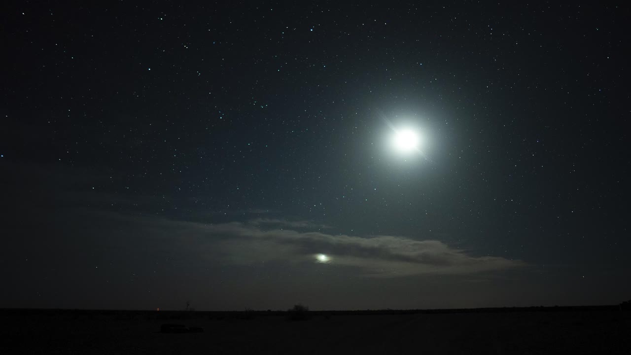 Timelapse of sunset at twilight going into the night with clouds, moon ...