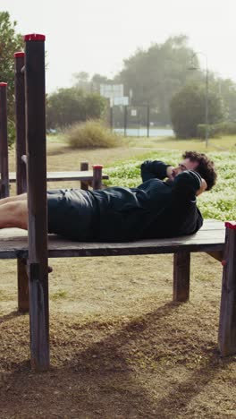 sun shines strongly on a man working out in the park