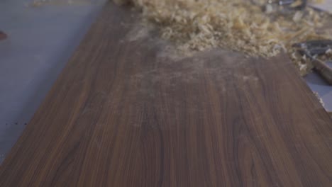 carpenter cleaning dust in slow motion.
