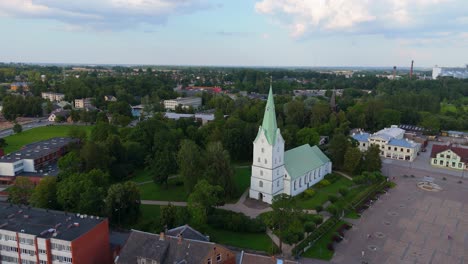 aerial panorama of dobele town center and evangelical lutheran church at summer scenic drone view in golden hour light over dobeles historic center on a warm summer evening peaceful latvian town