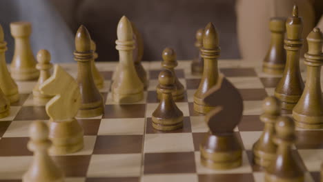 close up of two unrecognizable people playing chess