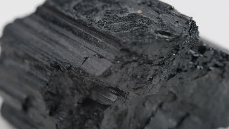 macro shot of abstract charcoal like rock spinning around showing rough texture on surface