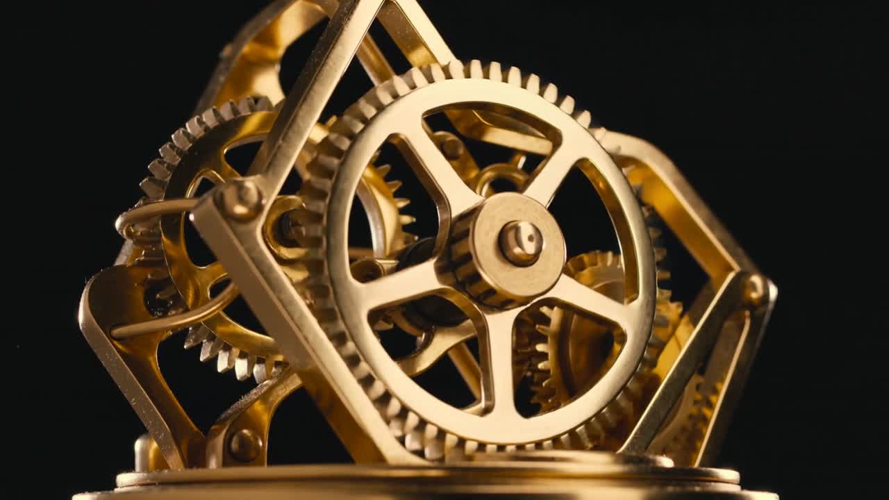 Brass gear assembly spinning after camera focus, revealing intermeshed pinions and warm reflections