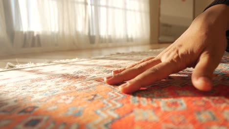 close up of a hand on a patterned rug