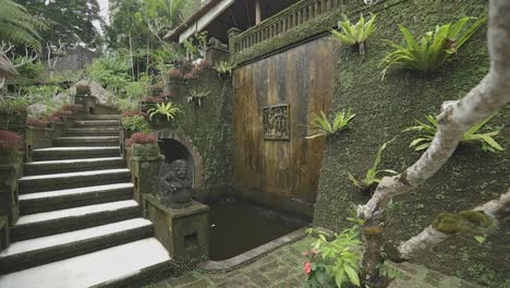 Slow-motion-gimbal-moves-through-lush-jungle-villa-with-balinese-fountain-dripping