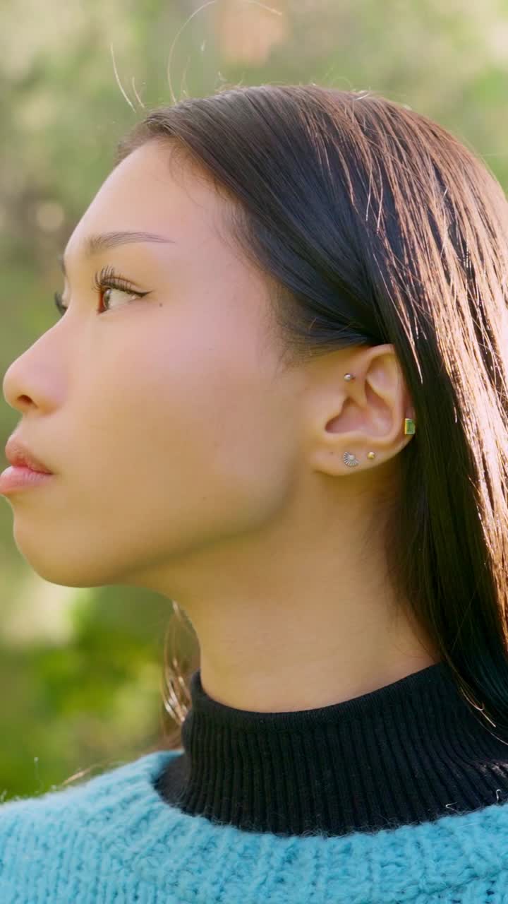 Close-up Profile of Young Asian Woman Looking Up Outdoors