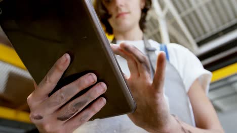 female welder using digital tablet in workshop 4k