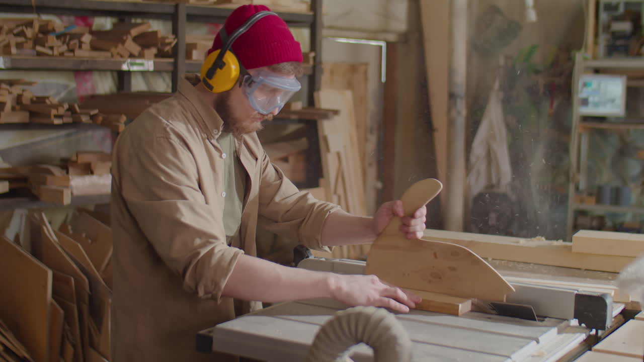 Carpenter Cutting Wooden Board with Table Saw