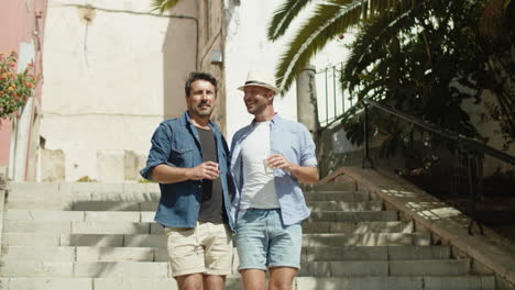 long shot of smiling homosexual men going down stairs in street