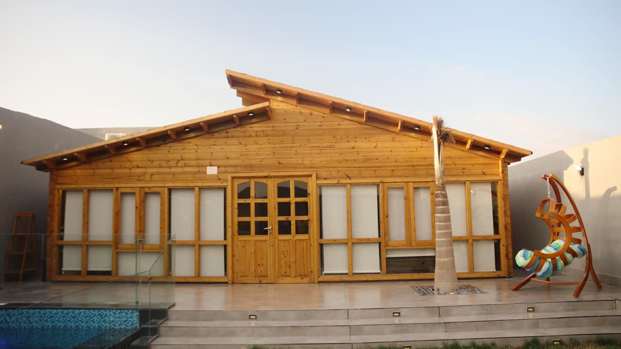 Pan right shot of newly built wooden house facade