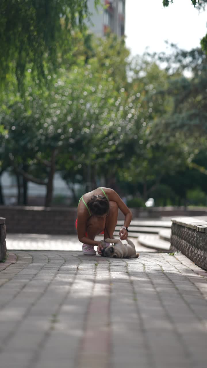 Woman and her pug in the park