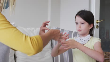 mother and daughter talking to each other through sign language