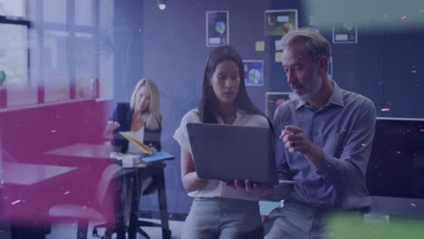 in modern office, colleagues discussing work using laptop with abstract animation overlay