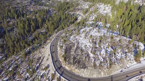 Aerial-drone-flyover-of-busy-winter-holiday-traffic-on-windy-Highway-50-in-the-Sierra-Nevada-mountains-near-Lake-Tahoe