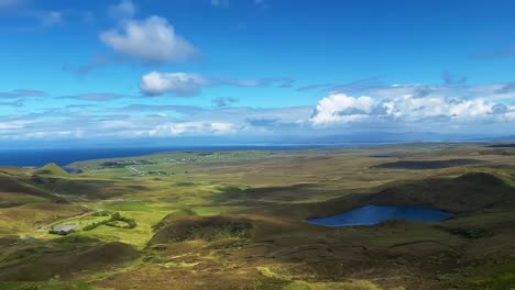 green lush mountain valley in quiraing on isle of skye in scotland - panning shot