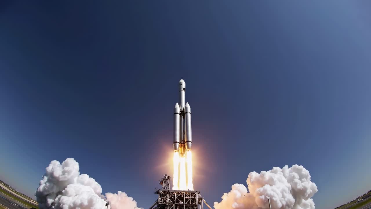 Launch of powerful rocket into clear blue sky from launch pad, showcasing modern space technology and exploration capabilities