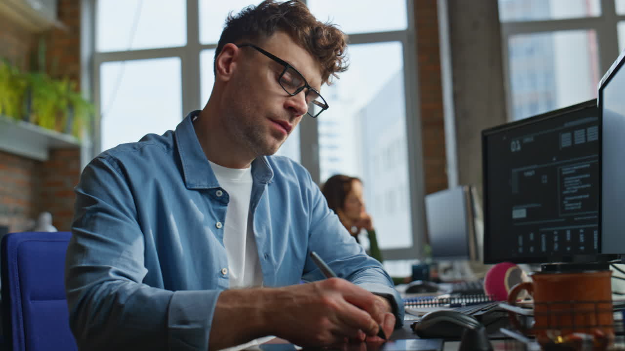 Eyeglasses developer typing keyboard writing code at office workplace closeup