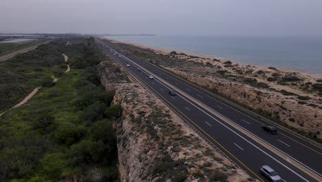 Aerial-view-of-the-Railway-Track-at-Moshav-Megadim-adjacent-to-the-highway-on-the-outskirts-of-Haifa,-Northern-Israel