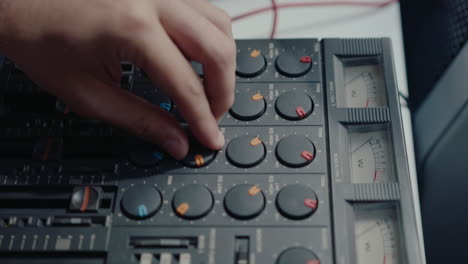 hands of musician using retro multitrack cassette recorder