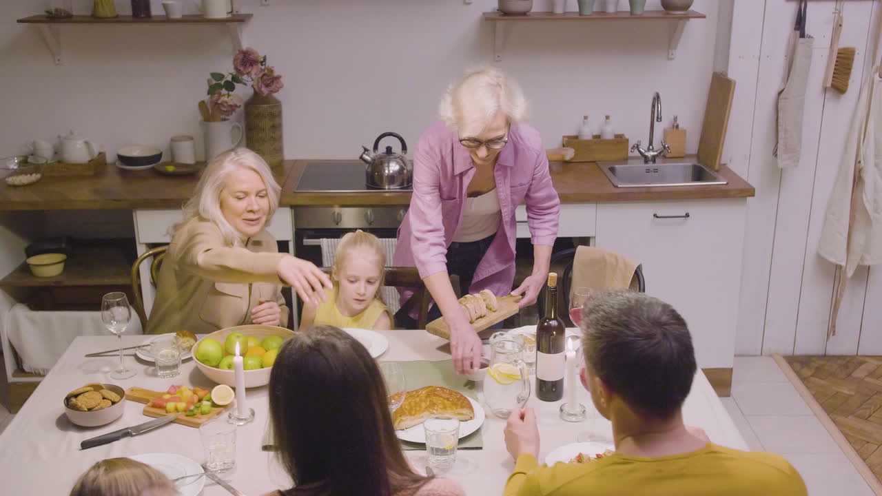 Top View Of Family Sitting At The Table During Dinner At Home