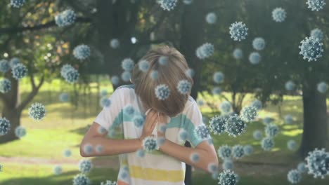 animation of macro covid-19 cells floating over caucasian boy sneezing