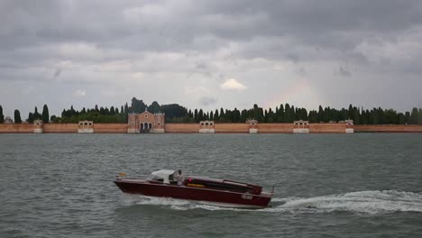 Traditional-Venetian-taxi-in-front-of-San-Michele-cemetery-island,-Venice,-Italy