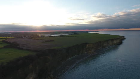 normandy coastline cliffs during sunset aerial drone view