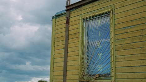 barred window on a wooden container house