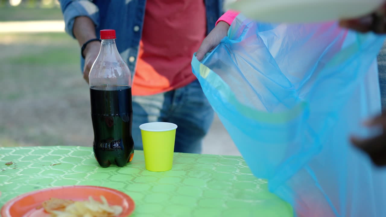 People enjoying an outdoor picnic with food and drinks