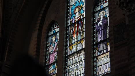 static shot of detailed stained glass windows within the cathedral in rotterdam